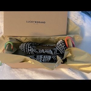 Size 7.5 black and white lucky shoes.